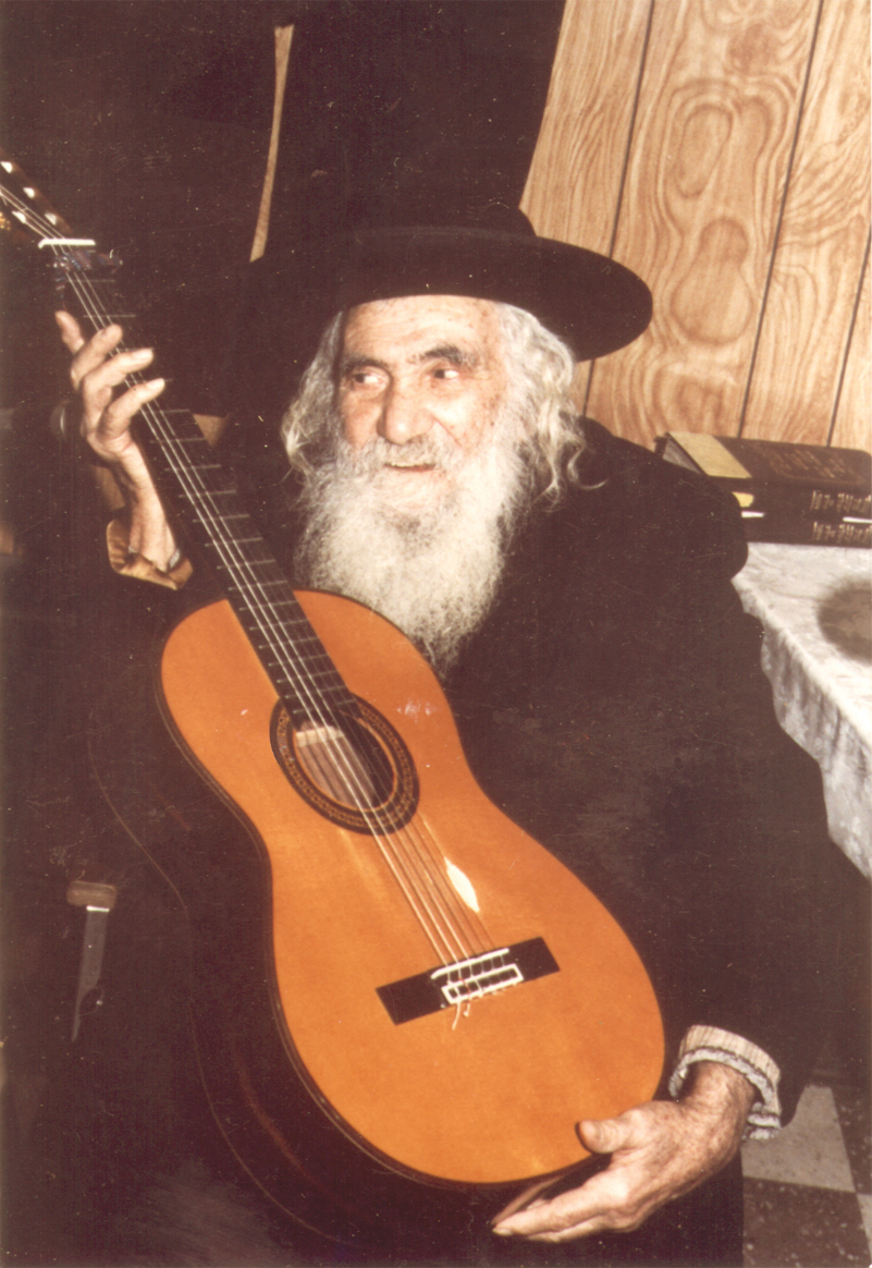 Rabbi Israel Ber Odesser holding Rabbi Carlebach Guitar